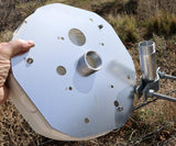 Metallic dish antenna held by a hand outdoors
